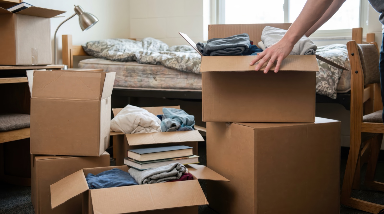 Personal belongings packed as a man moves into sober housing