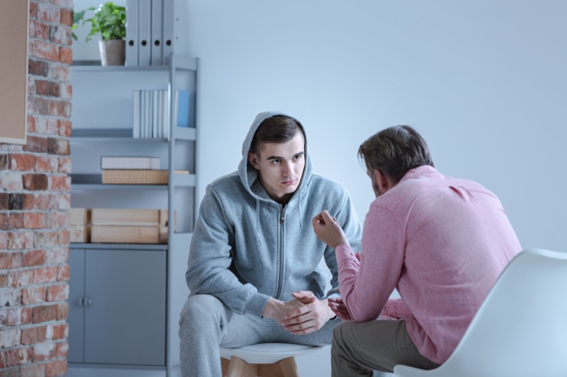 Counselor meeting one-on-one with a man in treatment