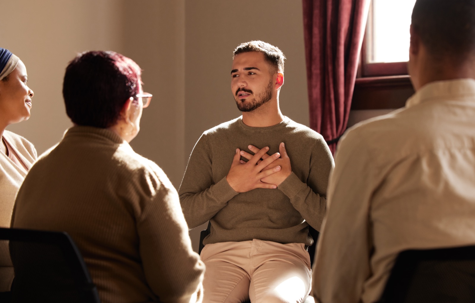 A man speaking openly during a recovery support group